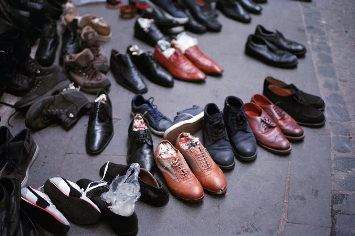 A collection of various men’s dress shoes in black, brown, and navy leather with laces.