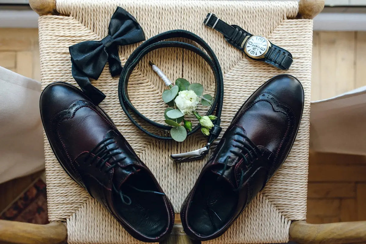 Black leather dress shoes with wingtip design and bow tie.