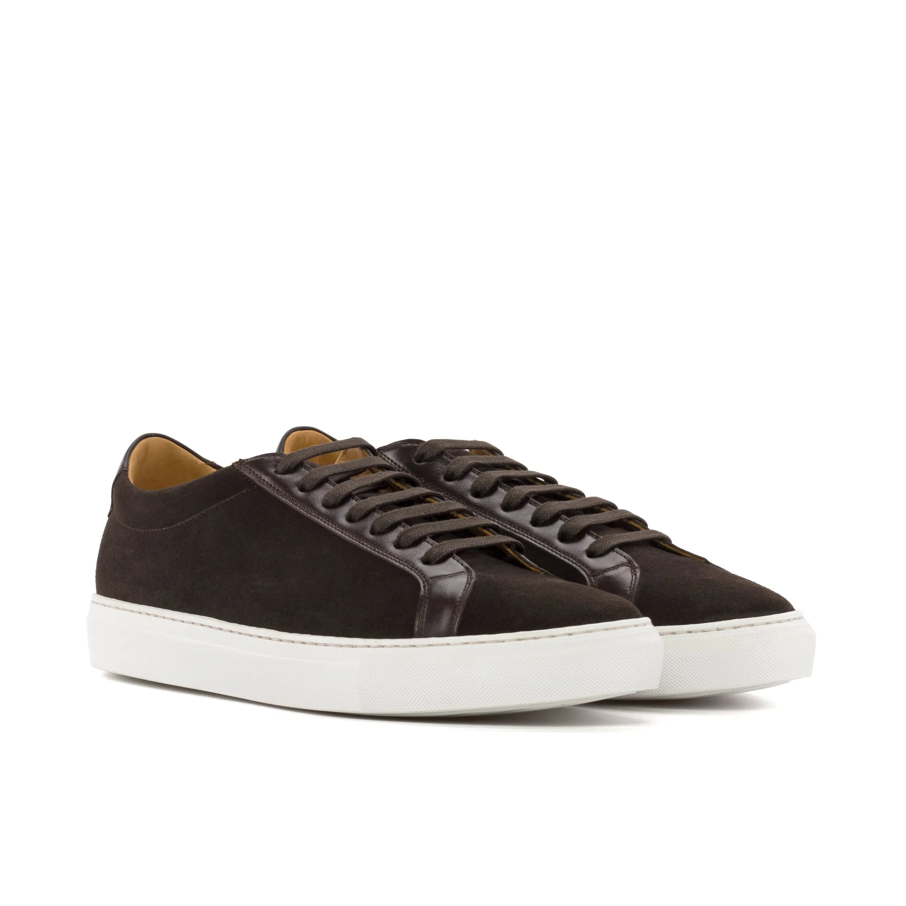 Dark brown suede and leather low-top sneakers with a white rubber sole.
