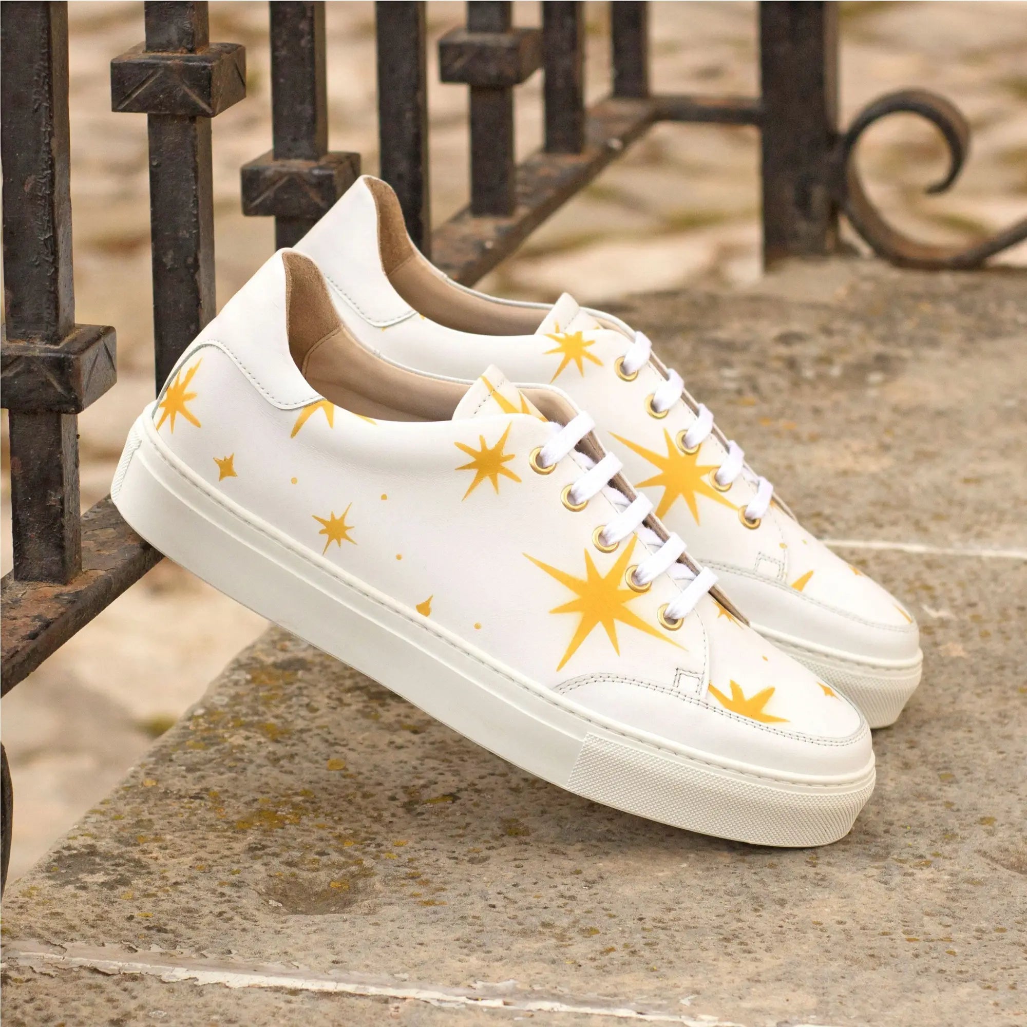 White sneakers with yellow starbursts.
