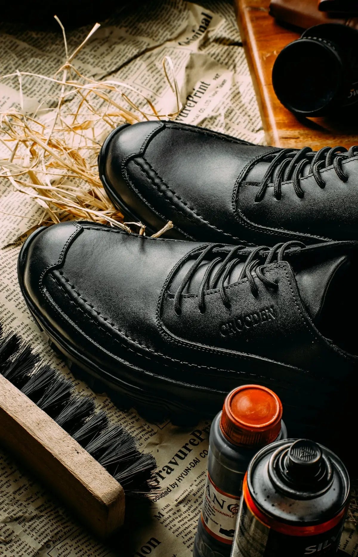 Black leather dress shoes with laces and a classic brogue design.
