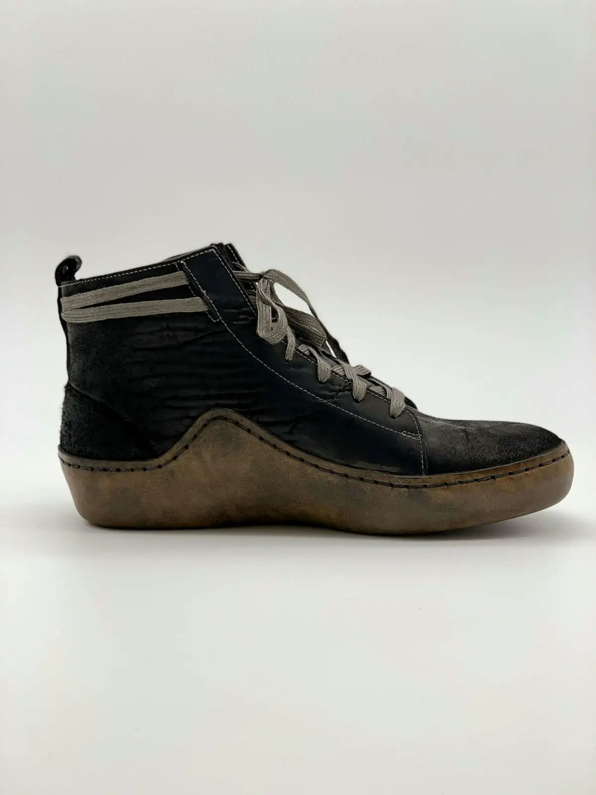 Black leather high-top sneaker with brown sole and laces, inspired by dr.