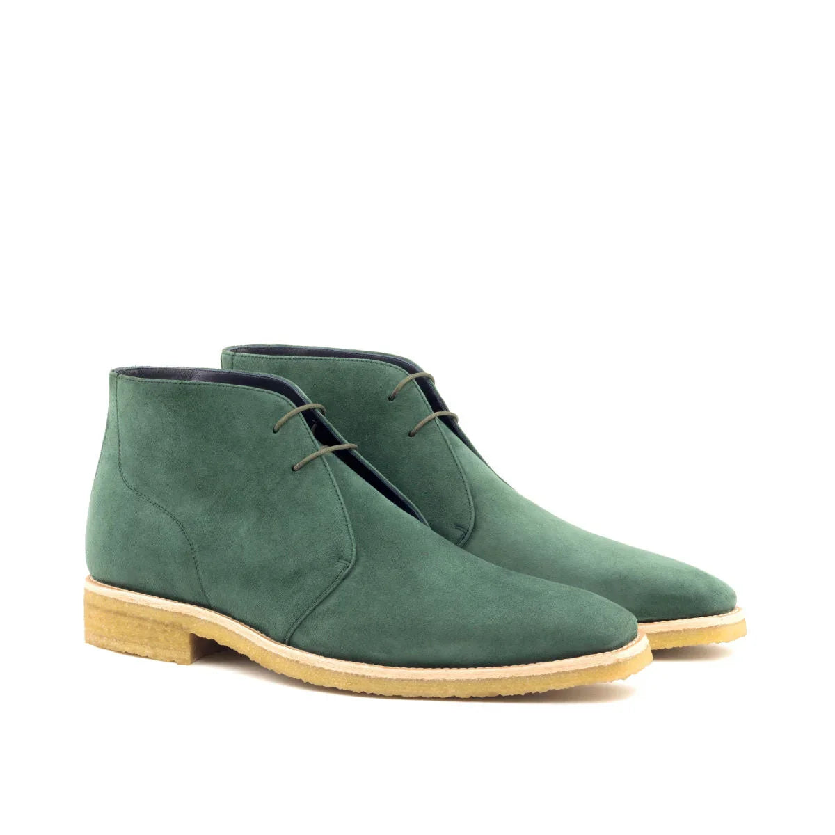 Dark green suede chukka boots with a light tan rubber sole and matching laces.