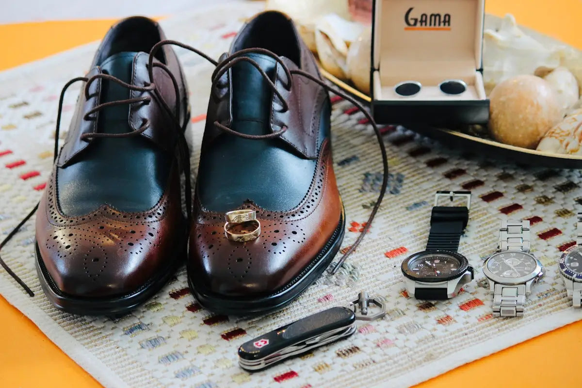 Brown leather wingtip oxford shoes with gold accents and a cap toe design.