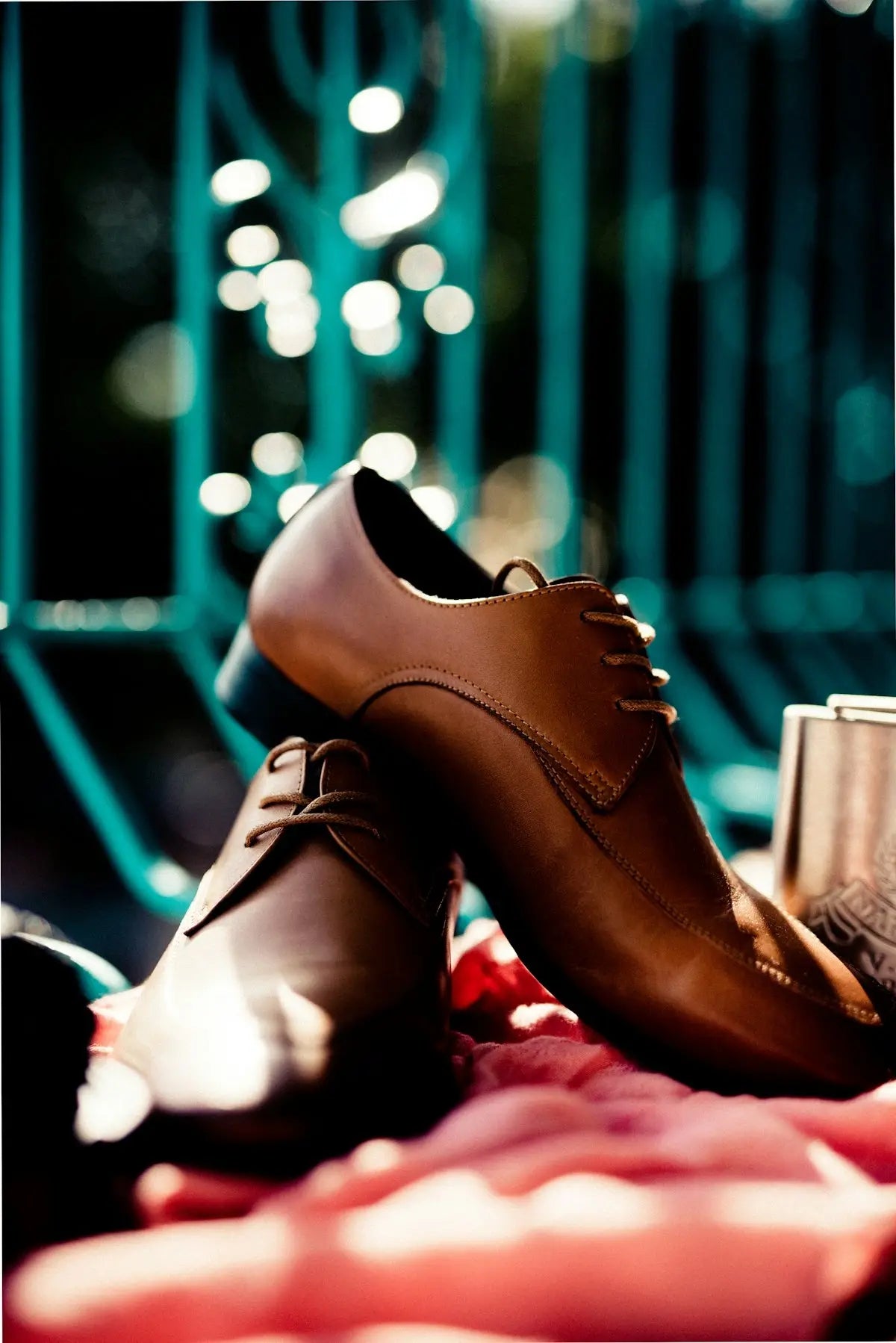 Brown leather oxford shoes with laces and tan stitching.
