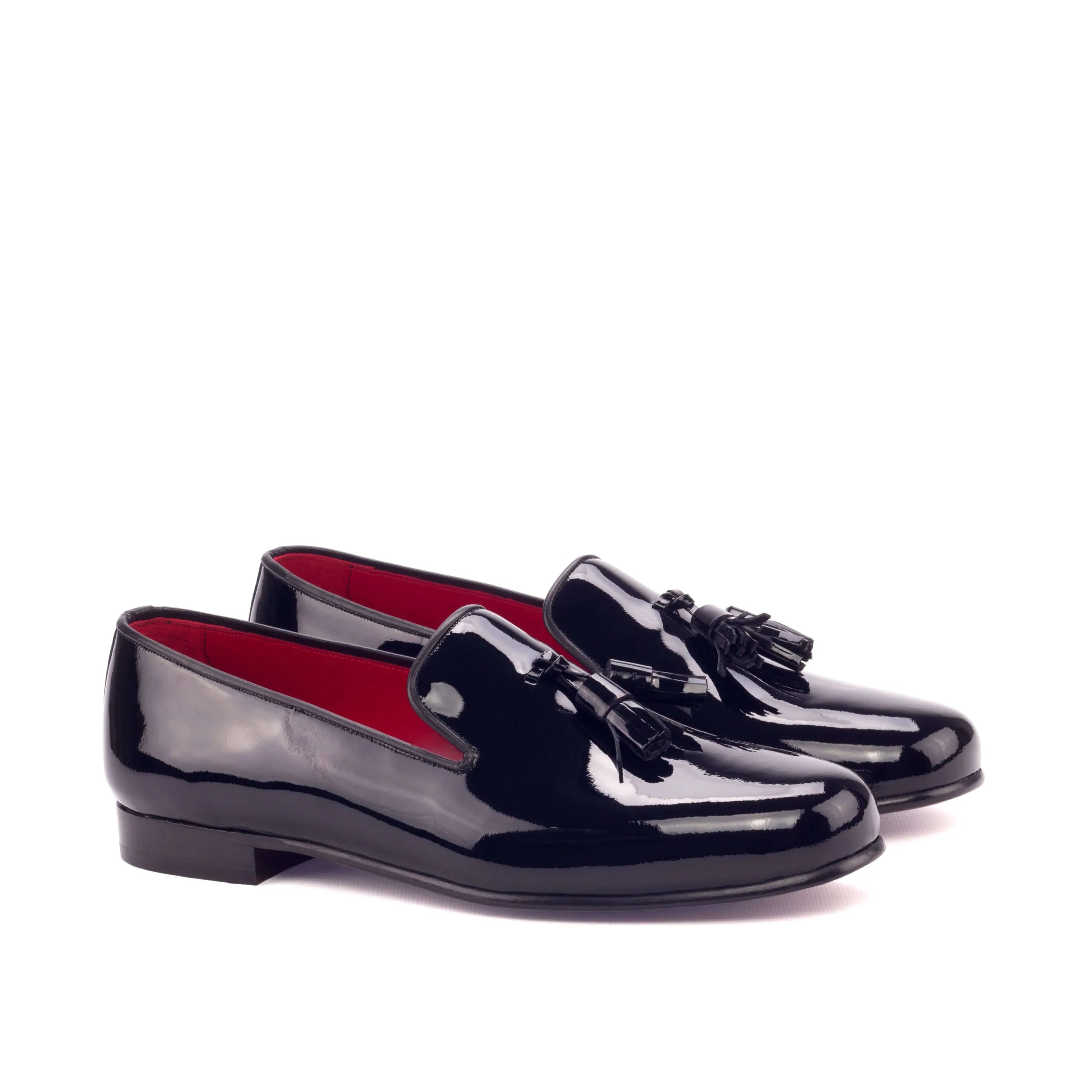 Pair of shiny black tassel loafers on Amuso Wellington slip on II