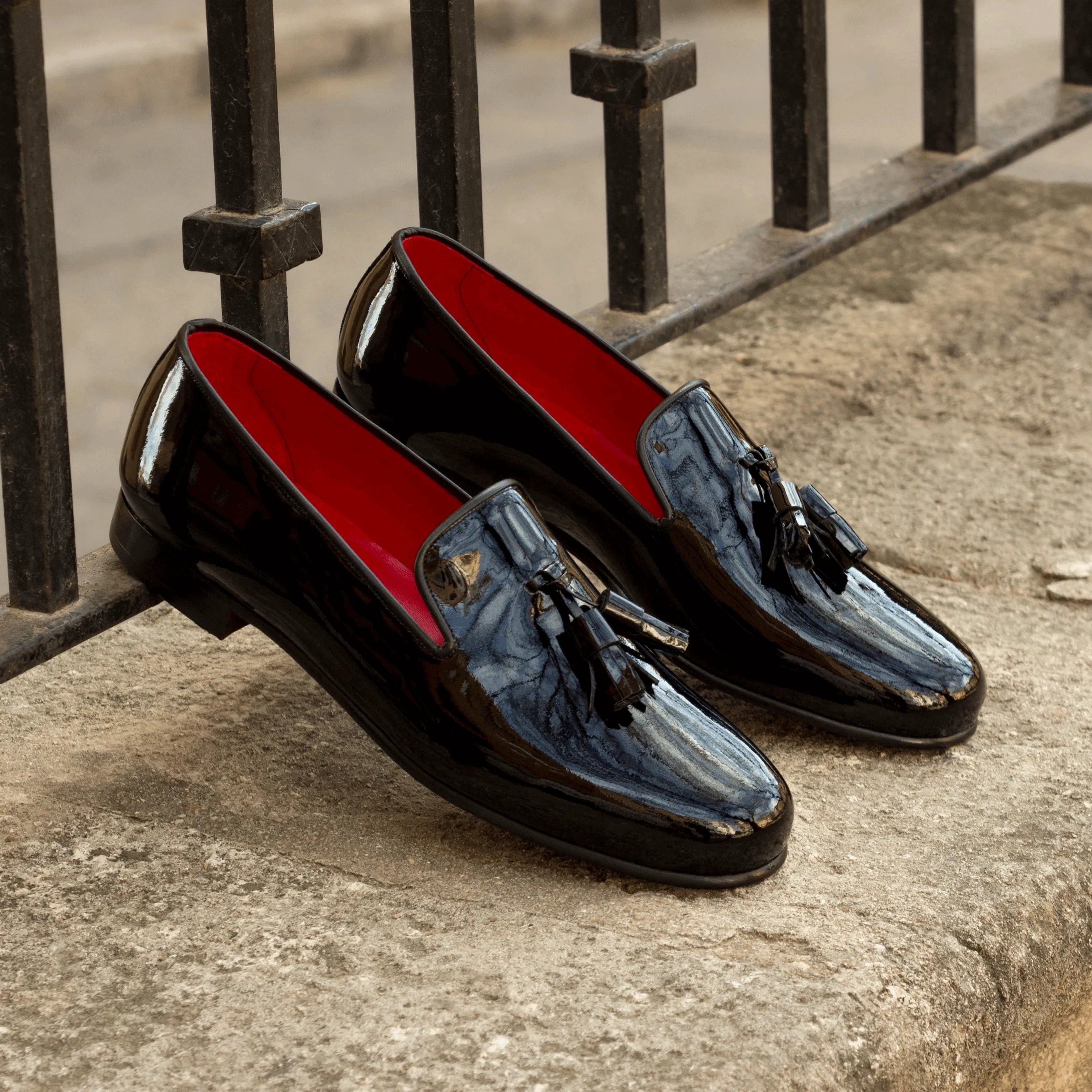 Pair of shiny black tassel loafers on Amuso Wellington slip