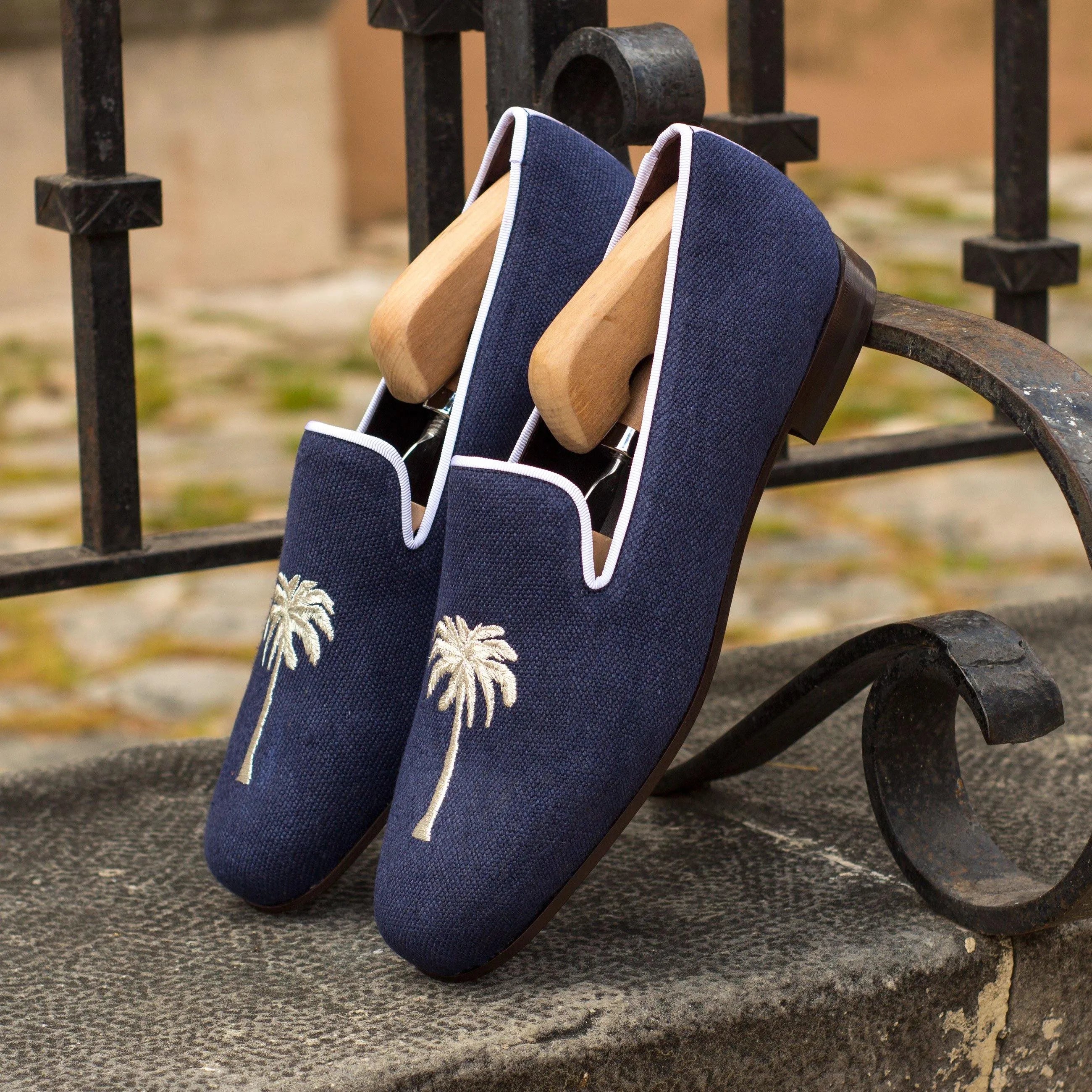 Navy blue Eagle Wellington Slip loafers with palm tree embroidery