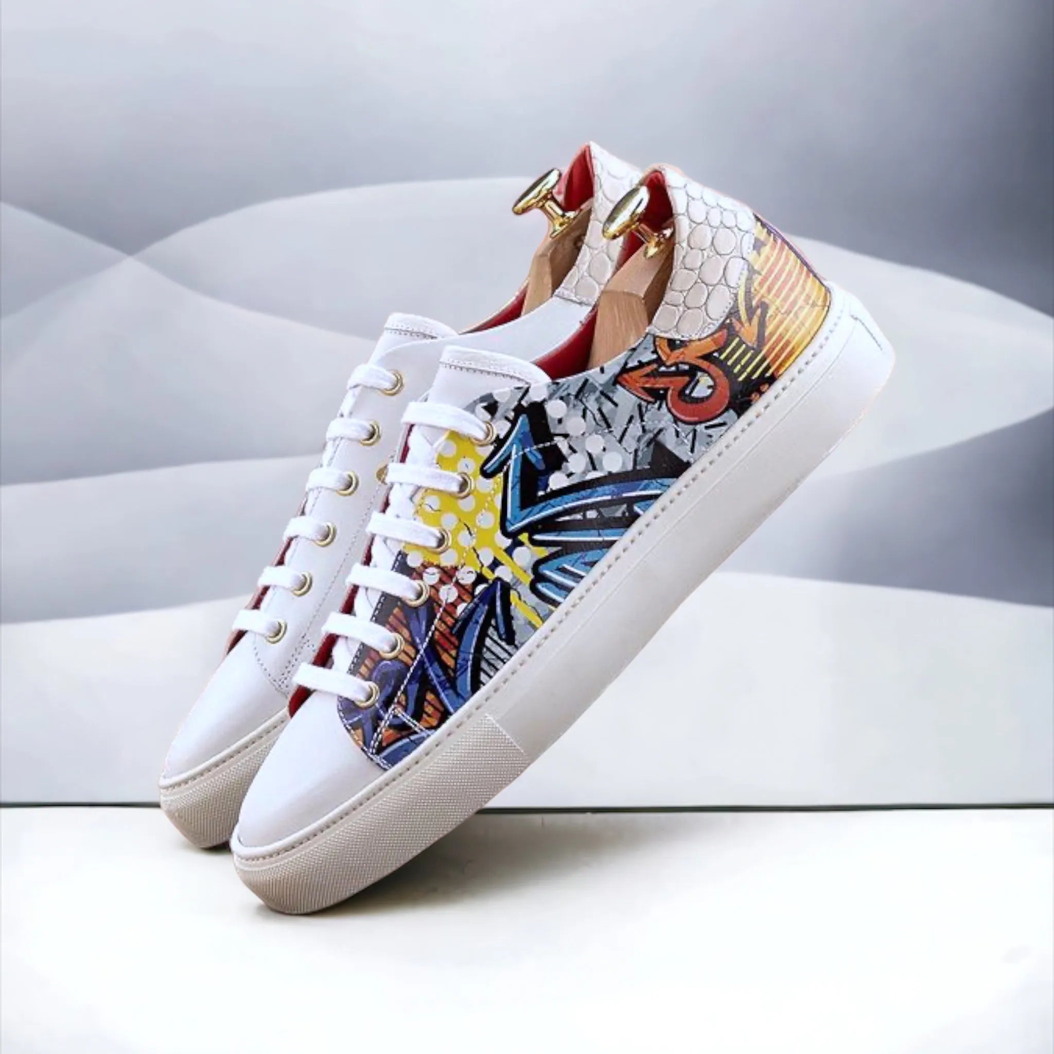 Ezy Trainer Sneaker: pair of white leather trainer sneakers with colorful graffiti
