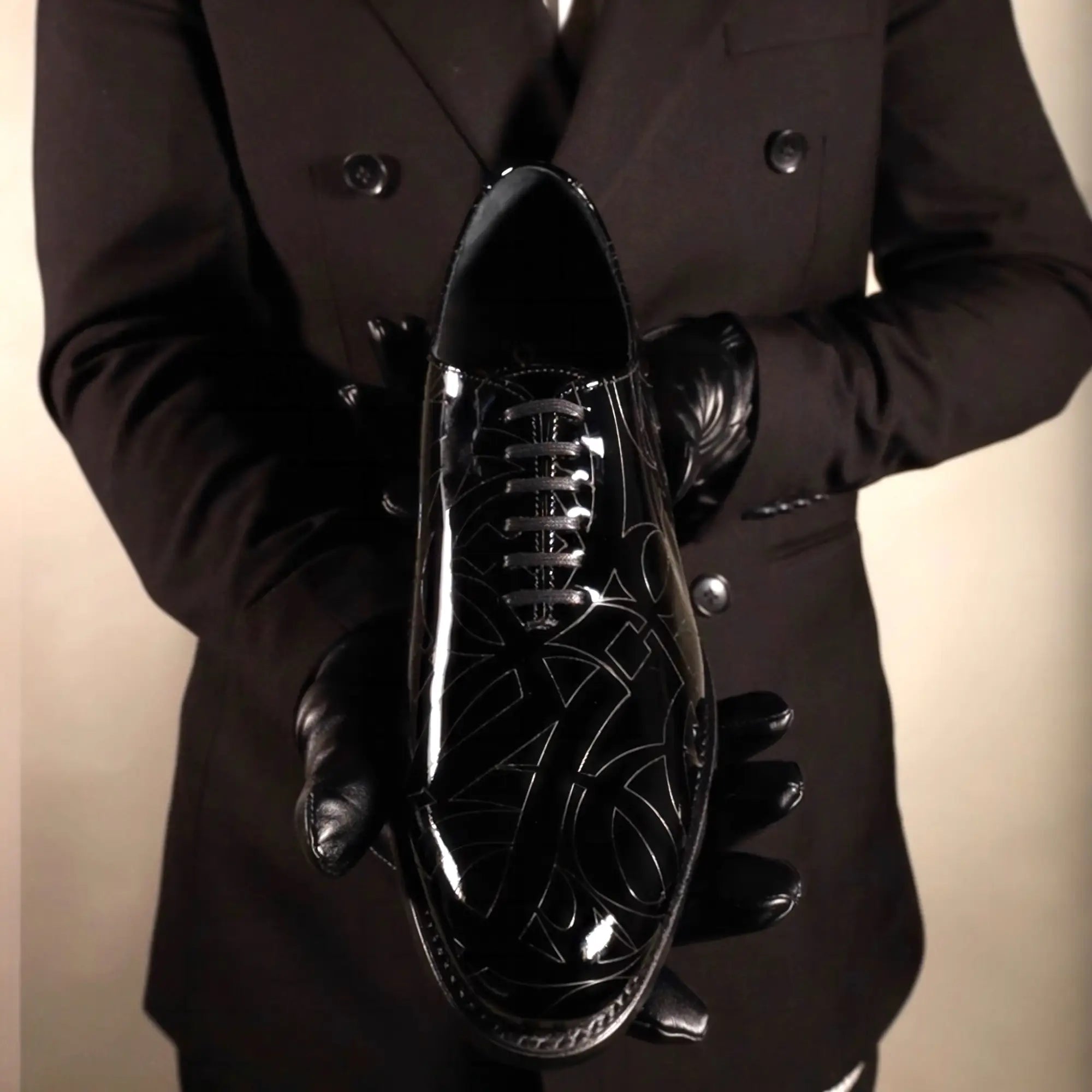 Shiny black dress shoe.