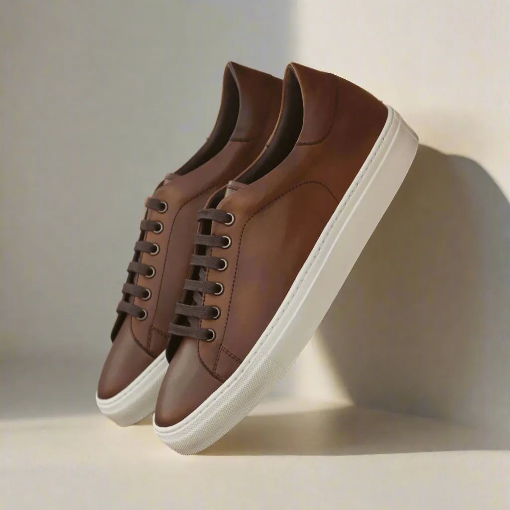 Claus Trainer Sneaker: pair of brown leather sneakers with white soles