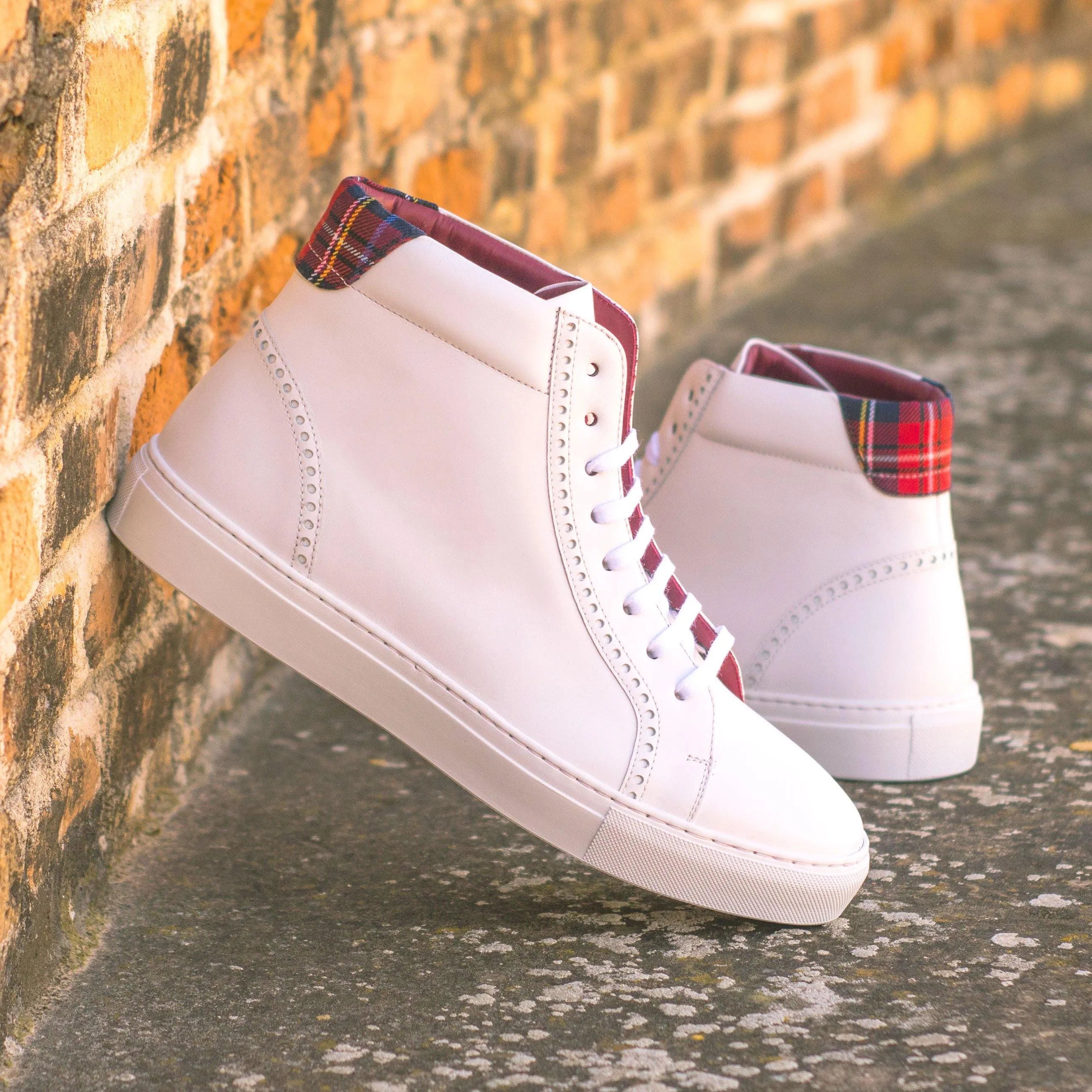 Pair of white Sky High Kicks high-top sneakers with plaid accents