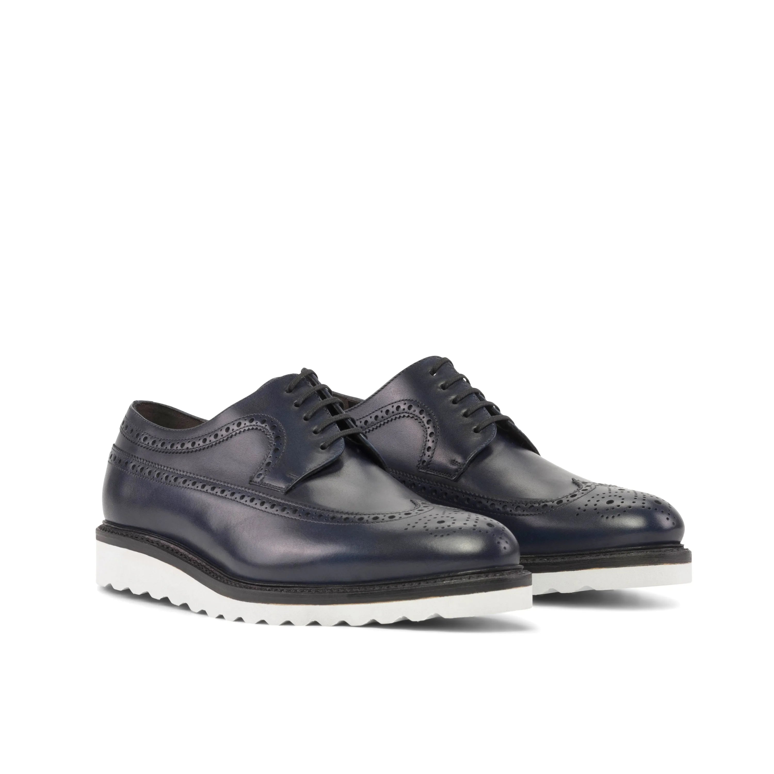 Pair of navy blue leather longwing blucher shoes with white soles
